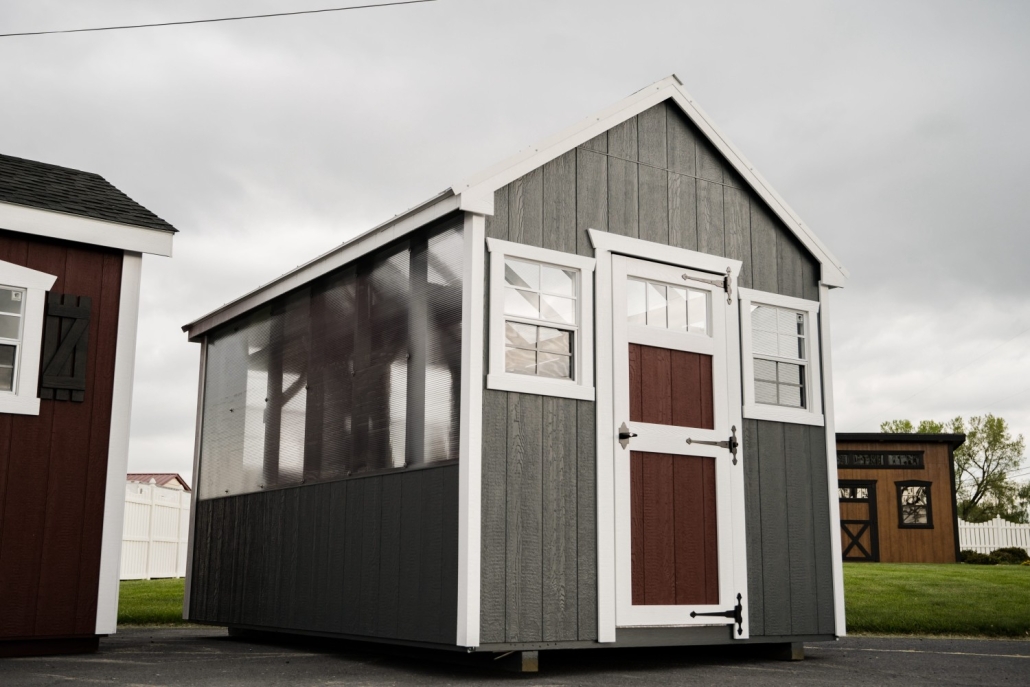 Valley Structures greenhouse with gray siding and wood trim