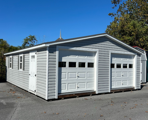 Garage with two bays/doors on a concrete lot